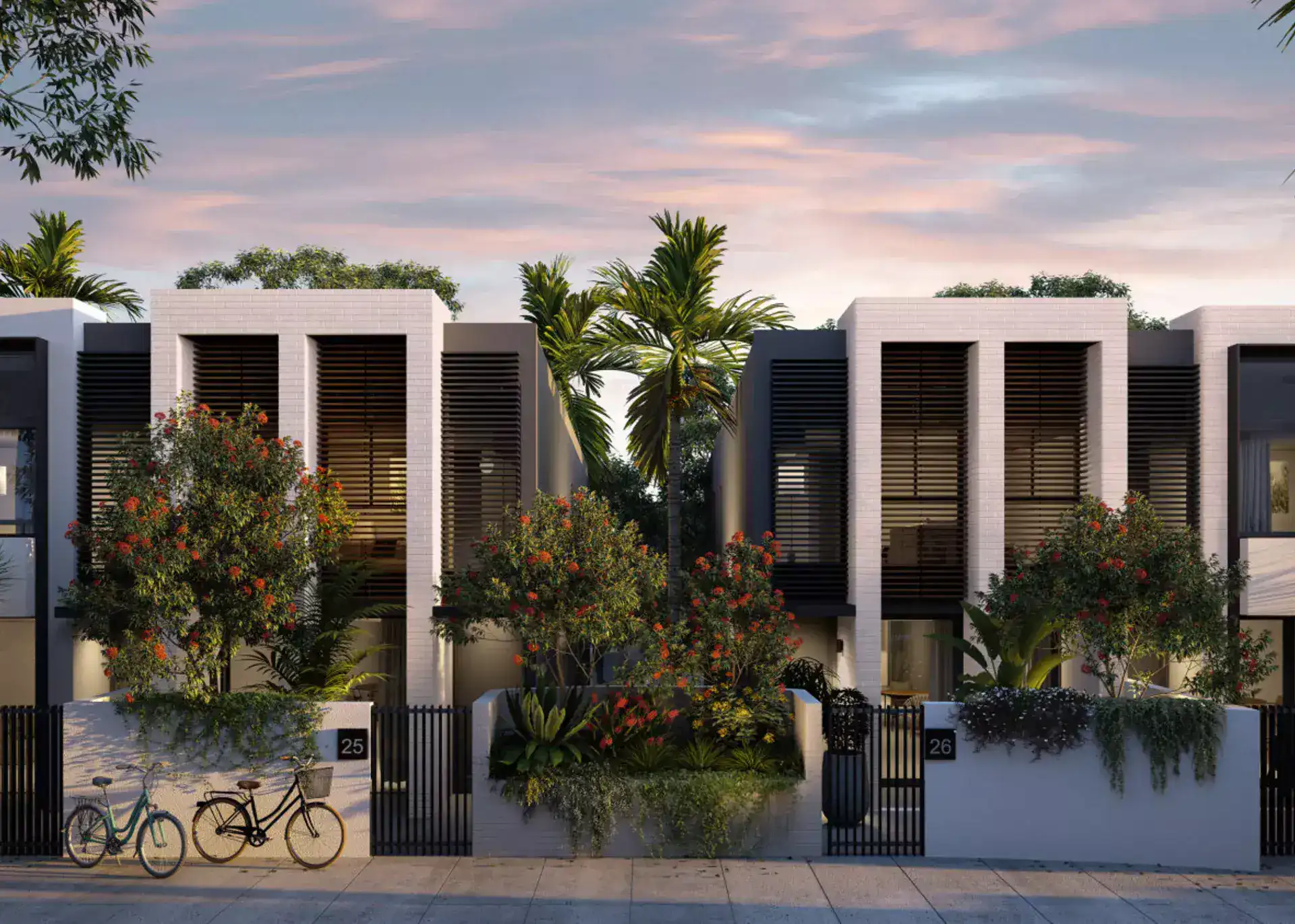 streetfront modern townhouses with coastal greenery at dusk